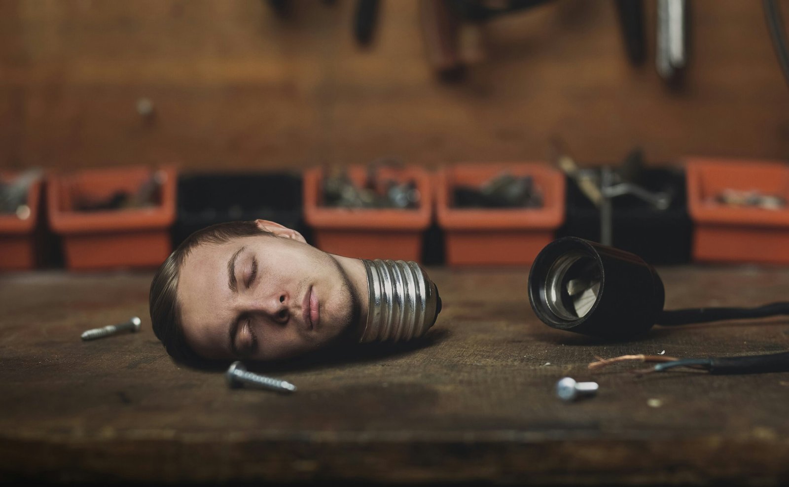 man lying on brown wooden table