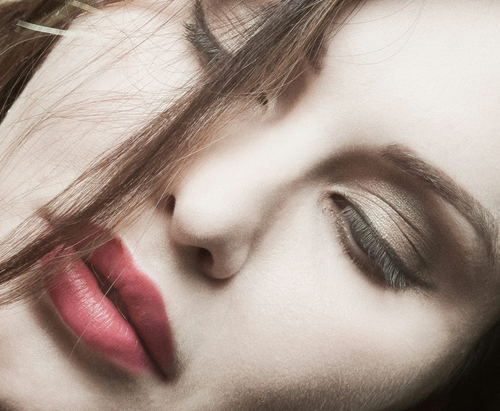 a close up of a woman's face with her eyes closed