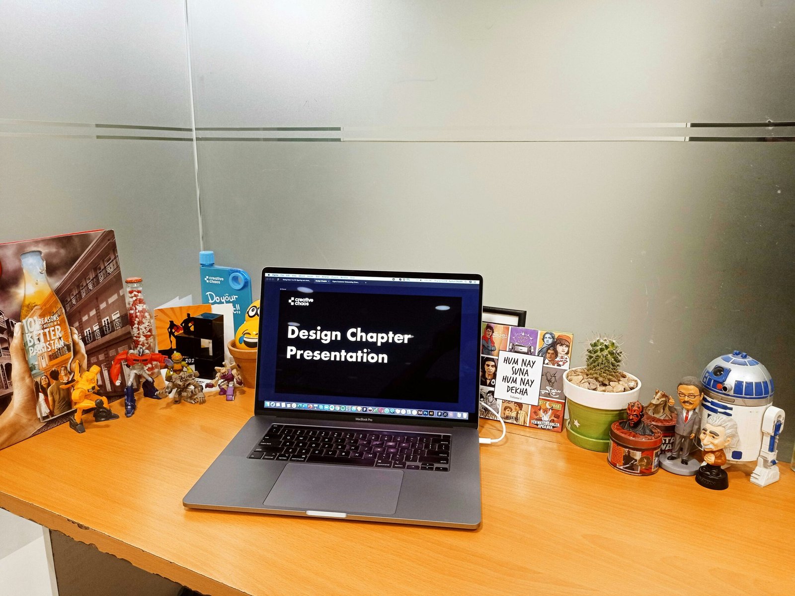a laptop computer sitting on top of a wooden desk