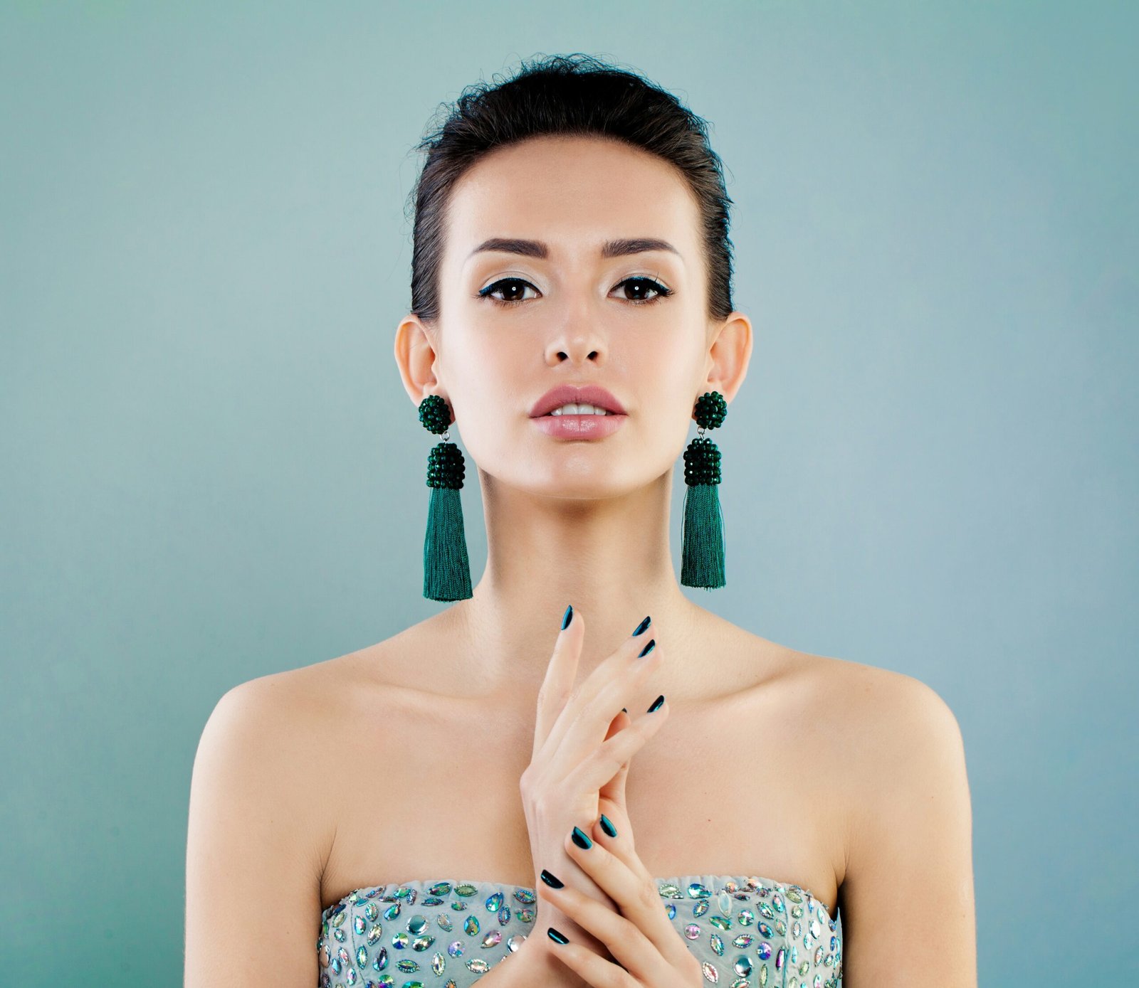 A woman in a strapless dress holding her hands together