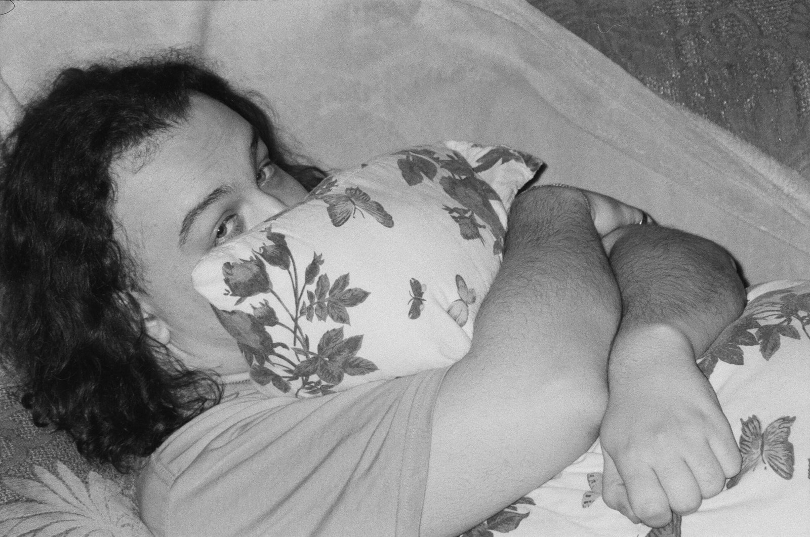 a black and white photo of a woman holding a baby