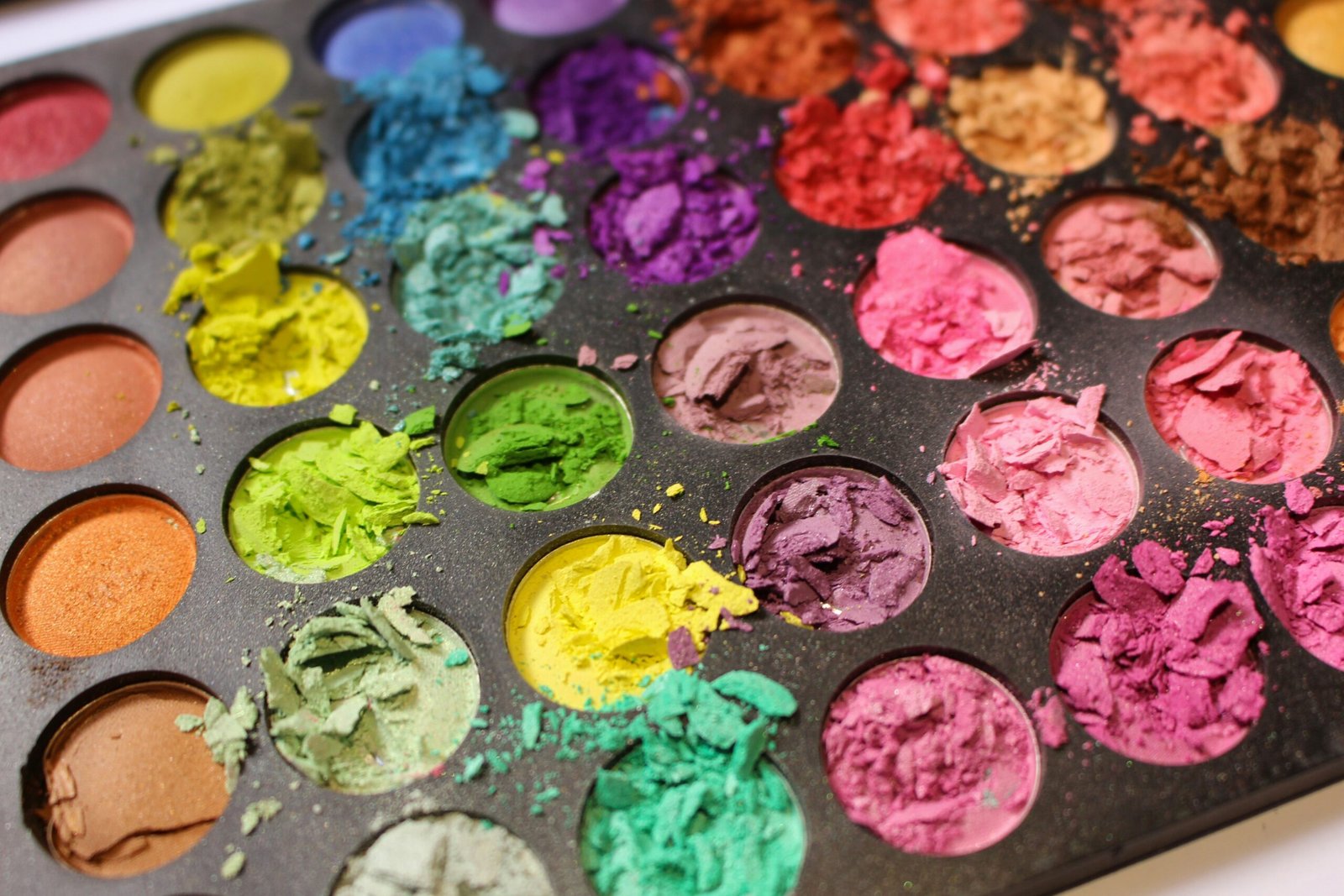 a close up of a tray of colorful powders