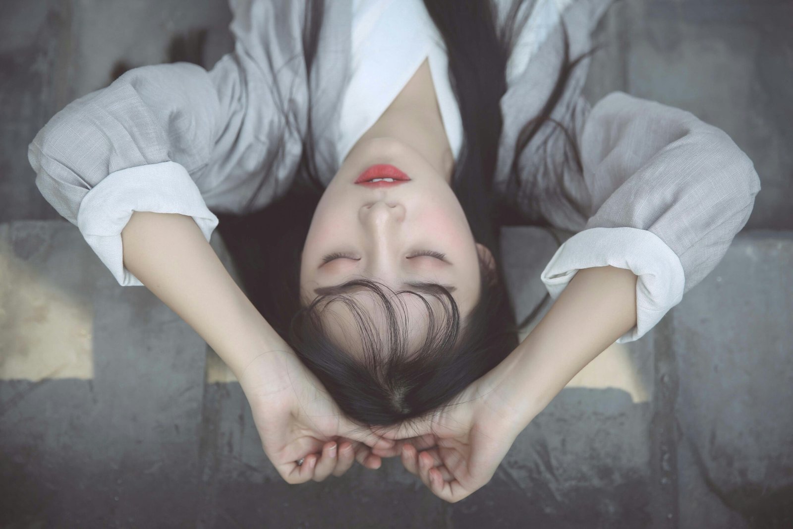 a woman with her hands on her head