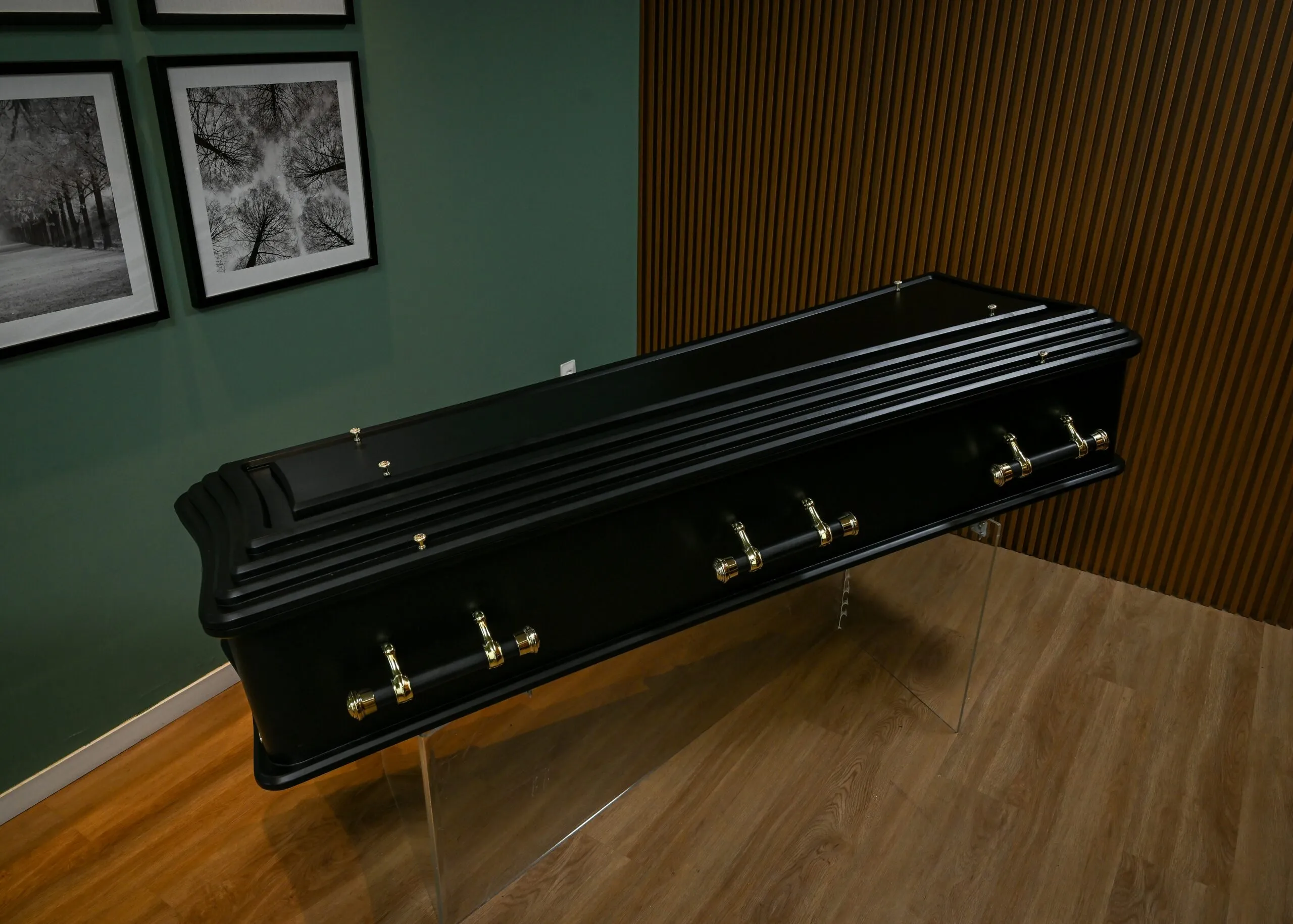 A black bench sitting on top of a hard wood floor