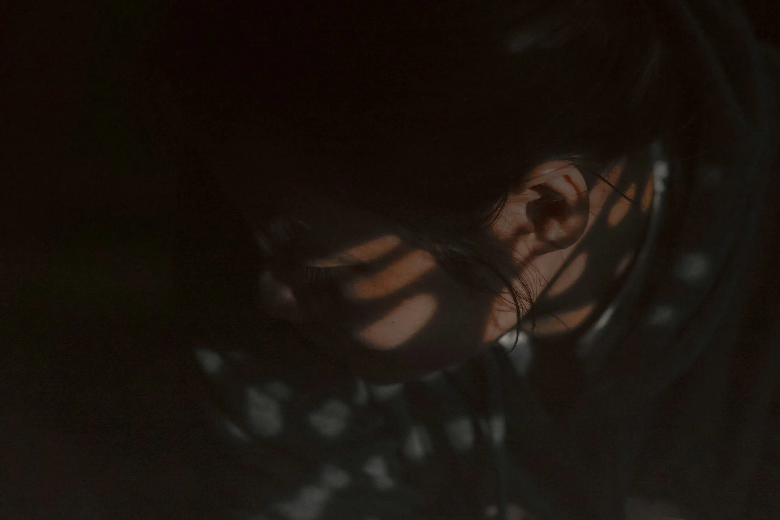 a close up of a person's face in the dark