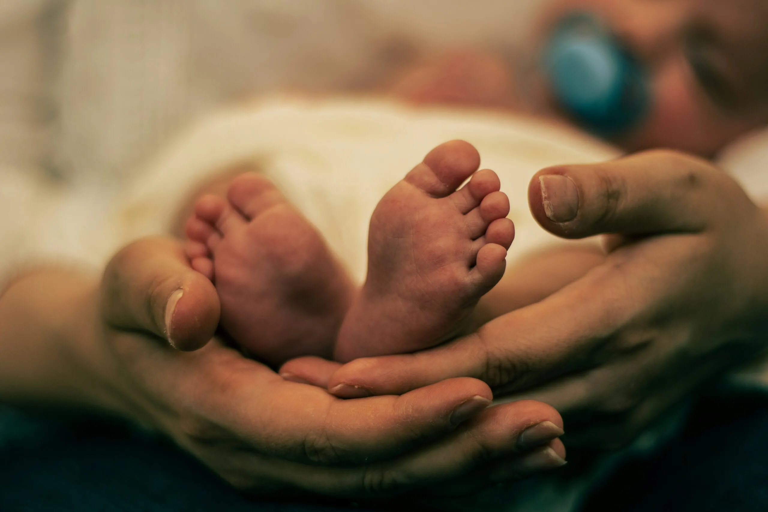 a close up of a person holding a baby