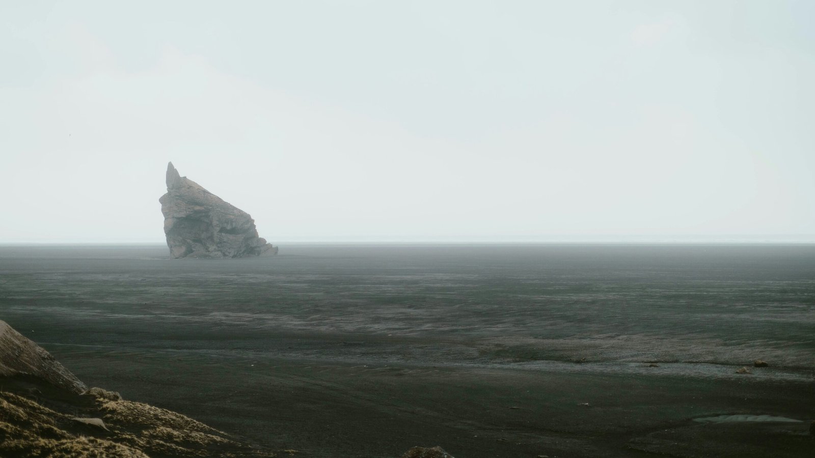 A solitary rock formation in the desert.
