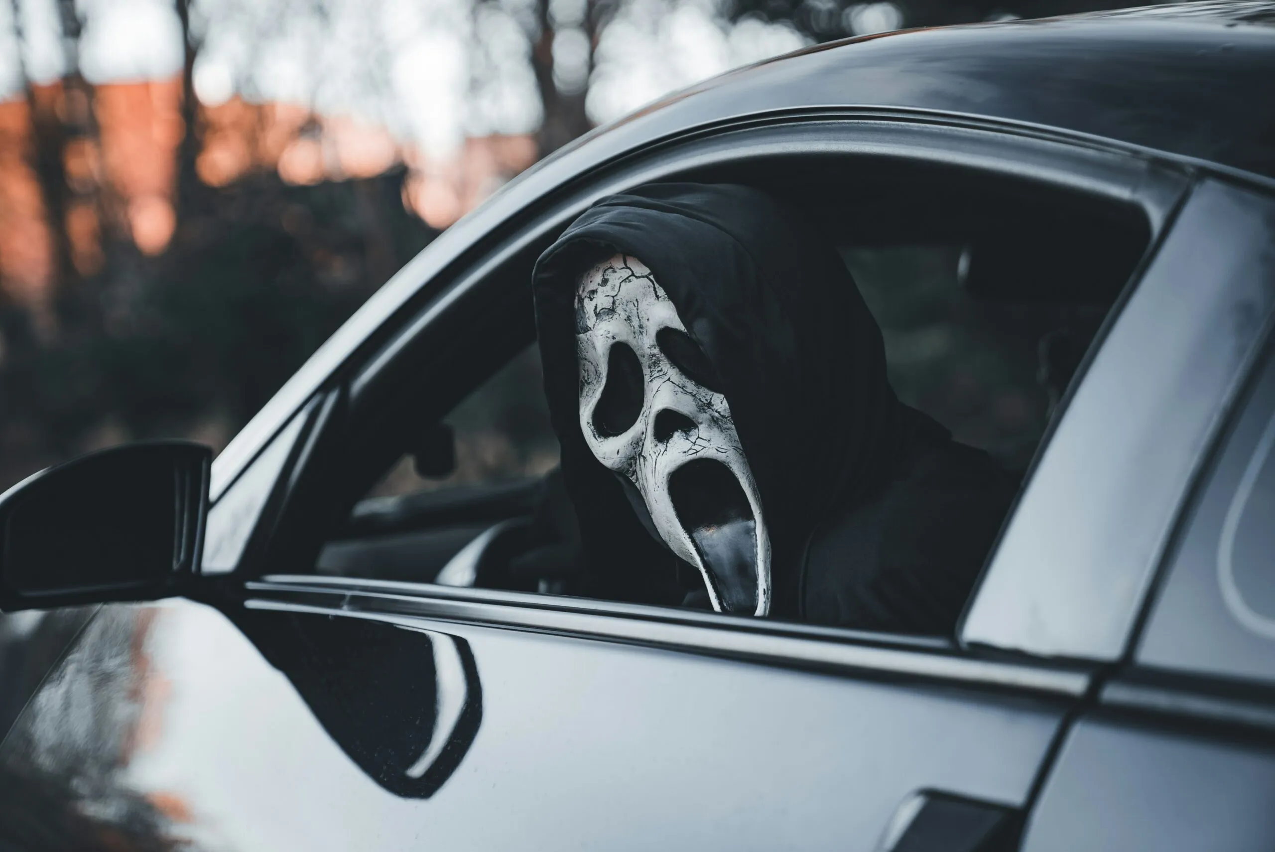 A black car with a white mask on it