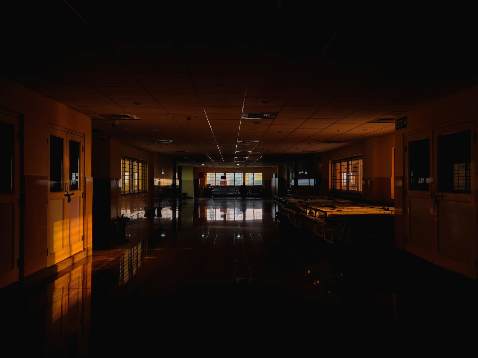 Dark hospital hallway with warm light