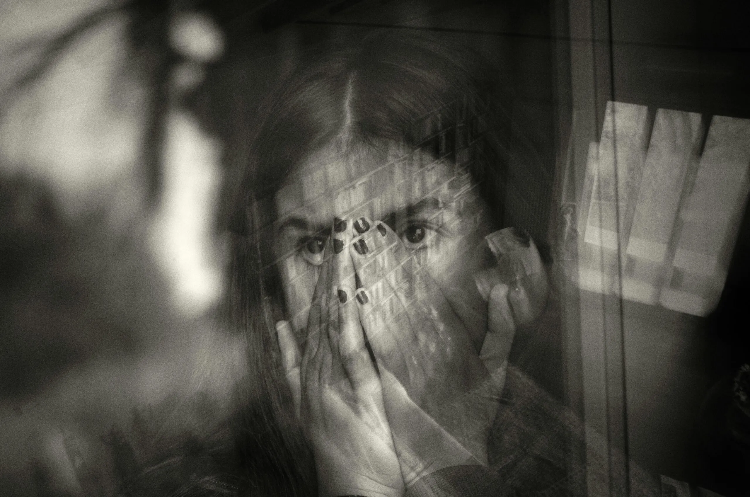 a woman covering her face with her hands