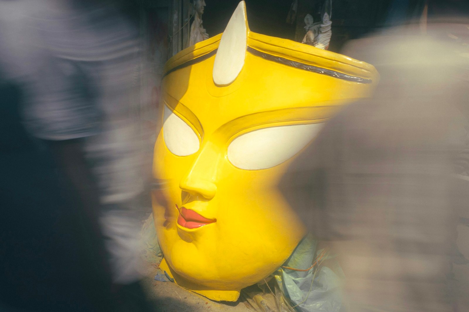 A close up of a yellow mask with horns