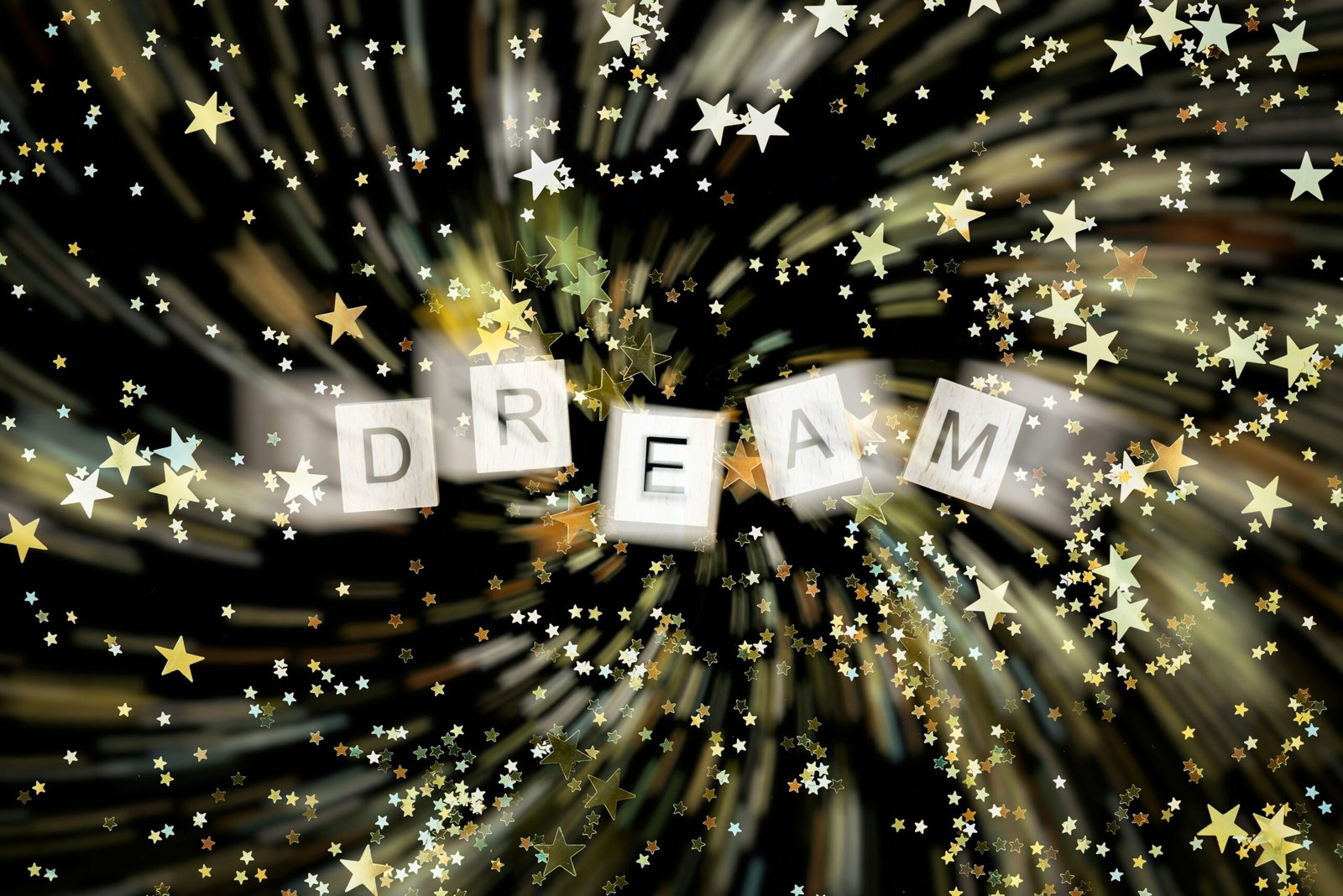 The word dream spelled with cube blocks surrounded by stars