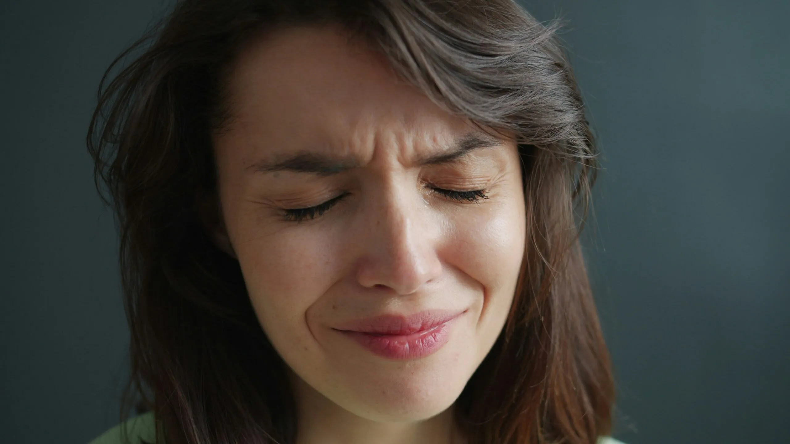 Woman with eyes closed and wrinkled nose