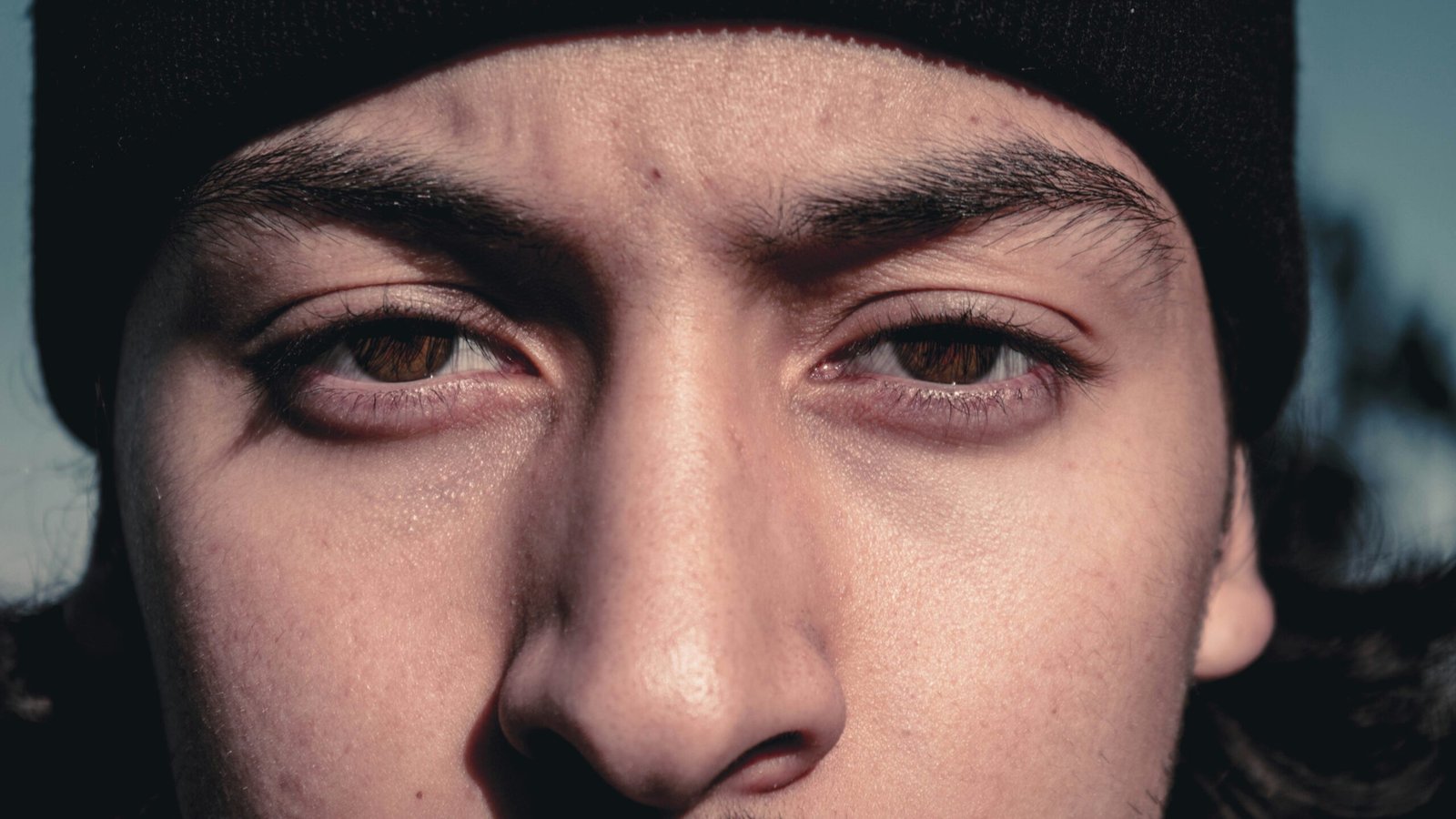 a close up of a person wearing a beanie