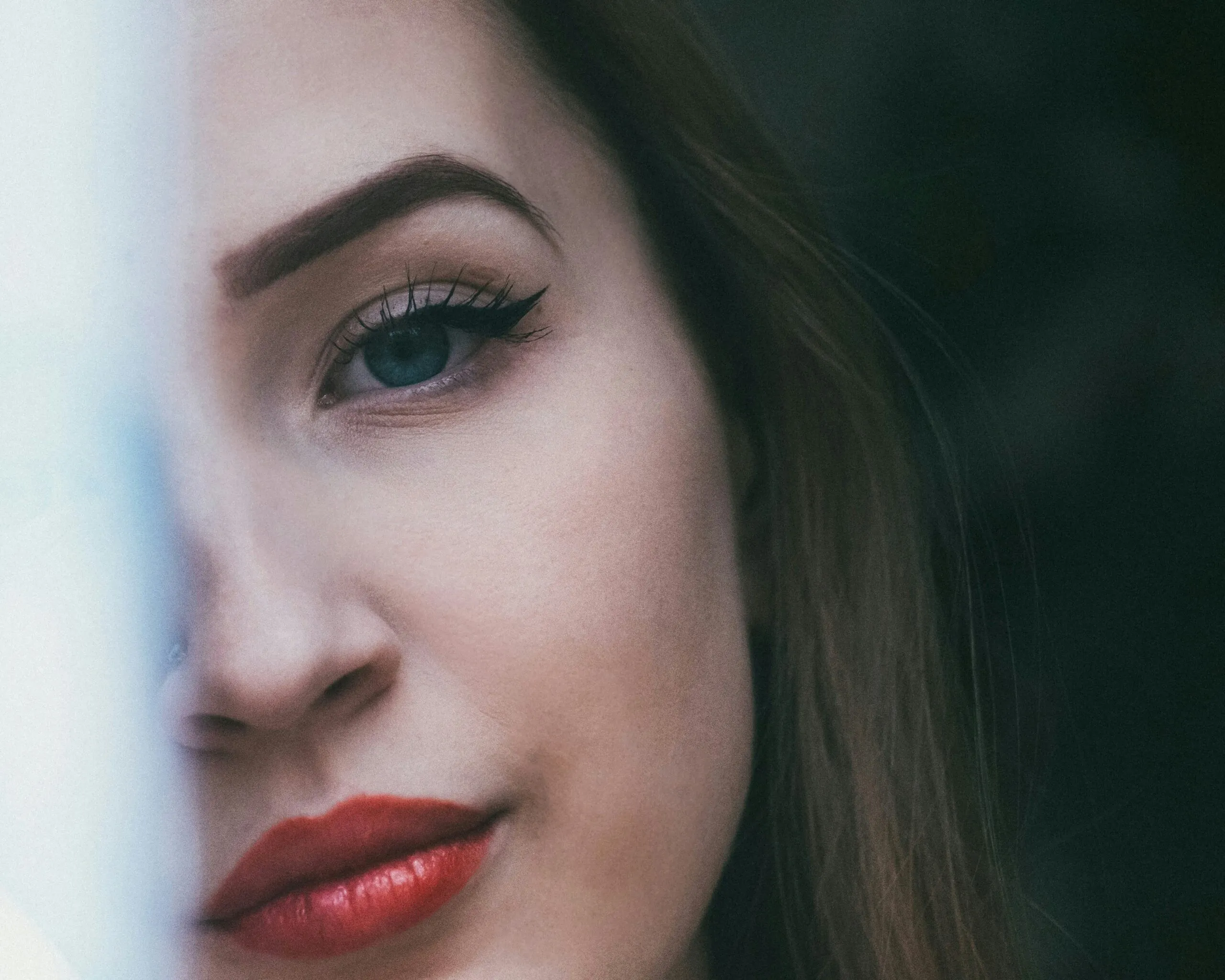 woman with red lipstick and black mascara