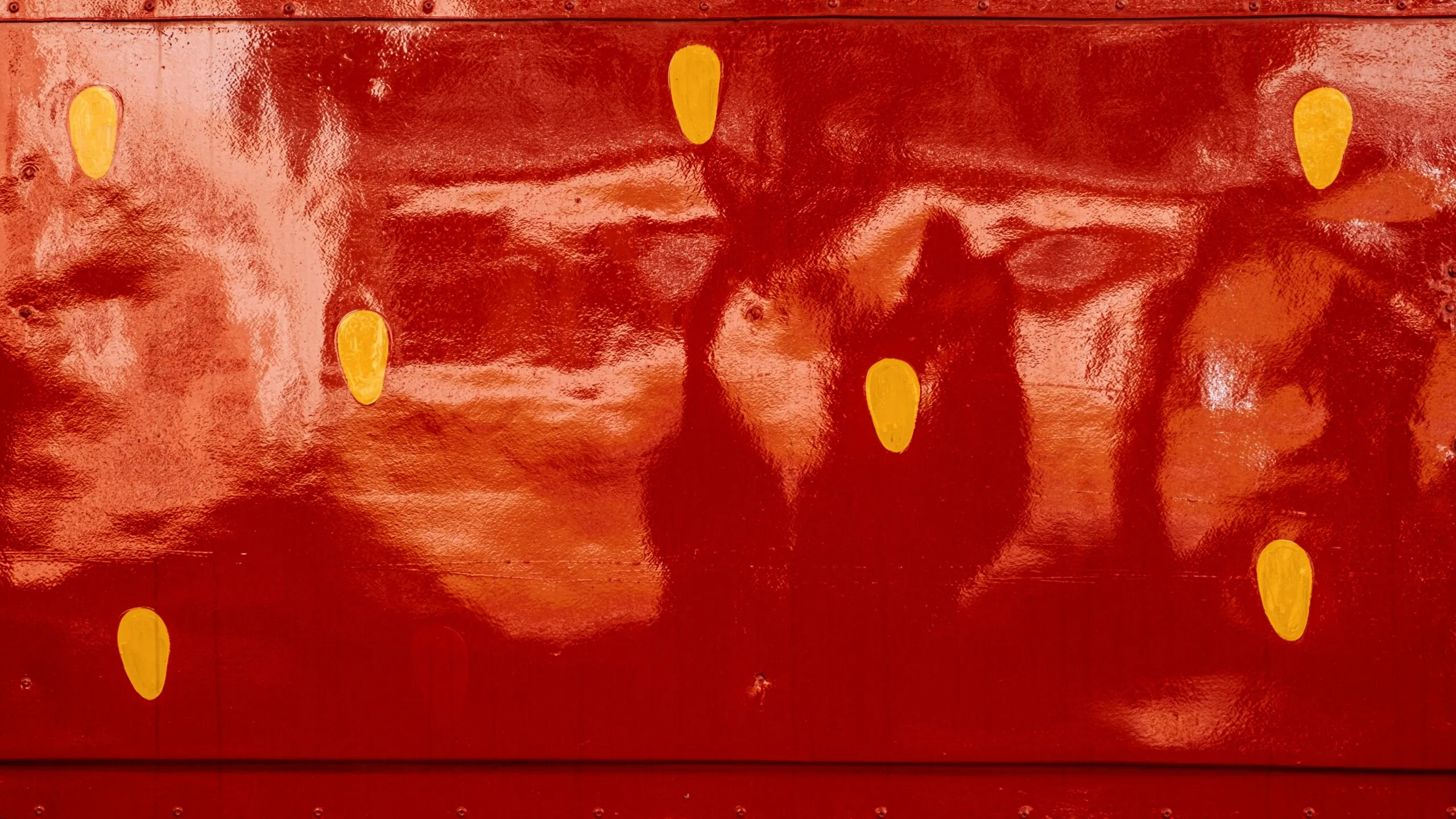 a red wall with yellow circles painted on it