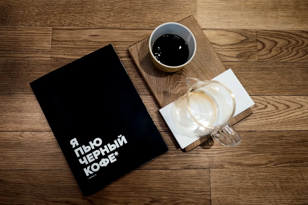 black and white ceramic mug on brown wooden table