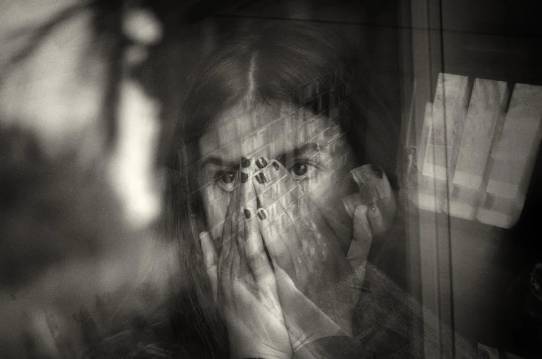 a woman covering her face with her hands