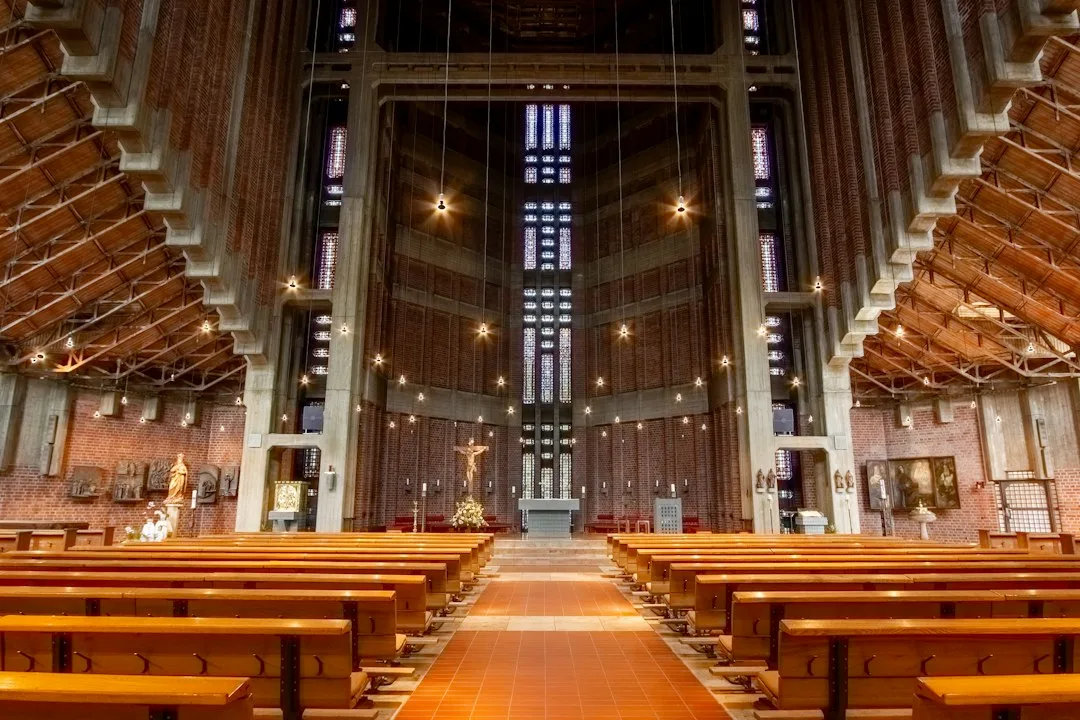 Interior of a modern church with wooden pews and altar.