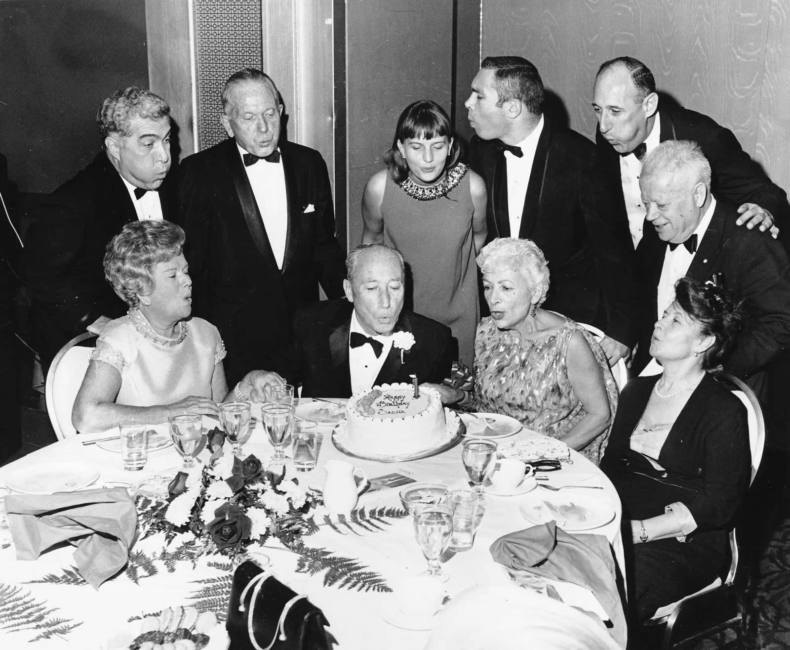 Title: Charles "Sasha" Zimmerman gets help from Louis Stulberg, David Dubinsky and other friends blowing out a birthday candle on a cake

           Date: 1980s Estimated
           
           Photographer: Unknown
           
           Photo ID:  5780pb47f1jp400g
           
           Collection: International Ladies Garment Workers Union Photographs (1885-1985)
           
           Repository: <a href="http://www.ilr.cornell.edu/library/kheel" rel="nofollow">The Kheel Center for Labor-Management Documentation and Archives</a> in the ILR School at Cornell University is the Catherwood Library unit that collects, preserves, and makes accessible special collections documenting the history of the workplace and labor relations. <a href="http://www.ilr.cornell.edu/library/kheel" rel="nofollow">www.ilr.cornell.edu/library/kheel</a>
           
           Notes: 
           
           Copyright: The copyright status of this image is unknown. It may also be subject to third party rights of privacy or publicity. Images are being made available for purposes of private study, scholarship, and research. The Kheel Center would like to learn more about this image and hear from any copyright owners who are not properly identified so that we may make the necessary corrections.
           

            Tags: Kheel Center for Labor-Management Documentation and Archives,Cornell University Library,Celebrations,  Union Officers,