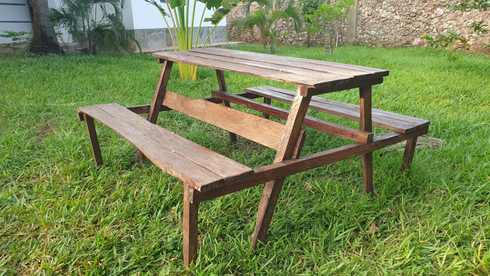 This all-weather DIY wood table and bench seat set complements the lovely garden; dining while watching the moon and stars is a memorable experience.