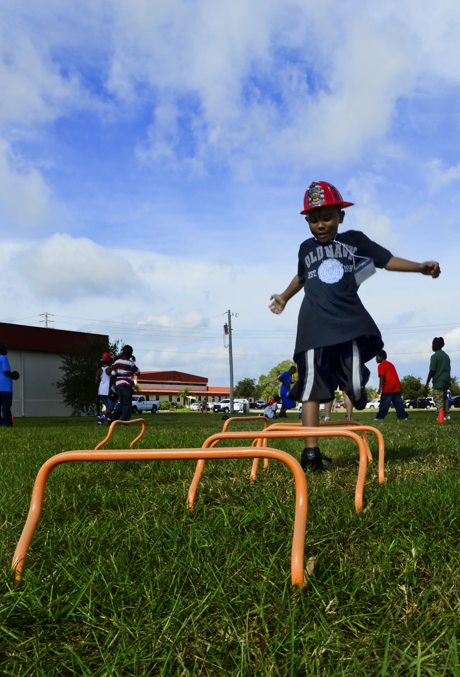 Donavyn, 6, jumps over a hurdle on the obstacle course during Big for a Day, Oct. 19, 2012, at MacDill Air Force Base, Fla. Team MacDill partnered with Big Brothers Big Sisters of Tampa Bay for the annual Big for a Day event where 103 service members volunteered to be “Bigs” for 60 children from the Tampa Bay community. (U.S. Air Force photo by Airman 1st Class Melanie Bulow-Kelly/Released)