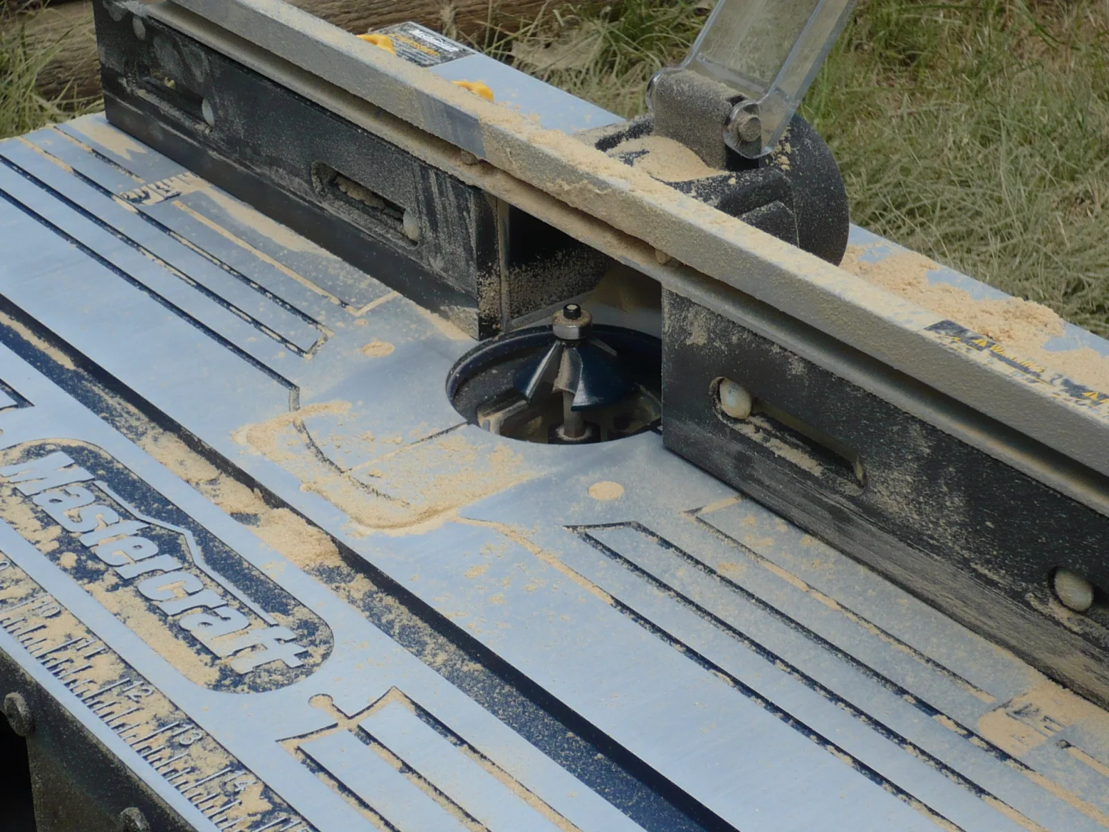 Photo of a Mastercraft brand router table covered with MDF sawdust.