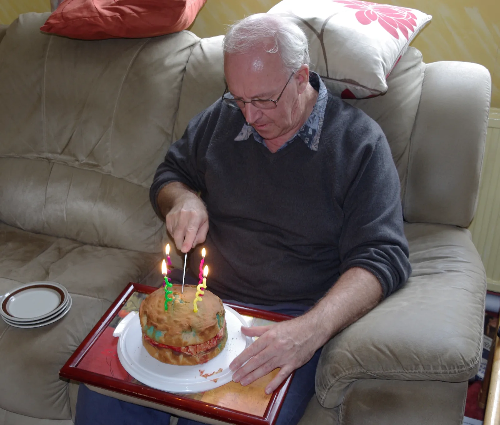 A man cuts his birthday cake.
