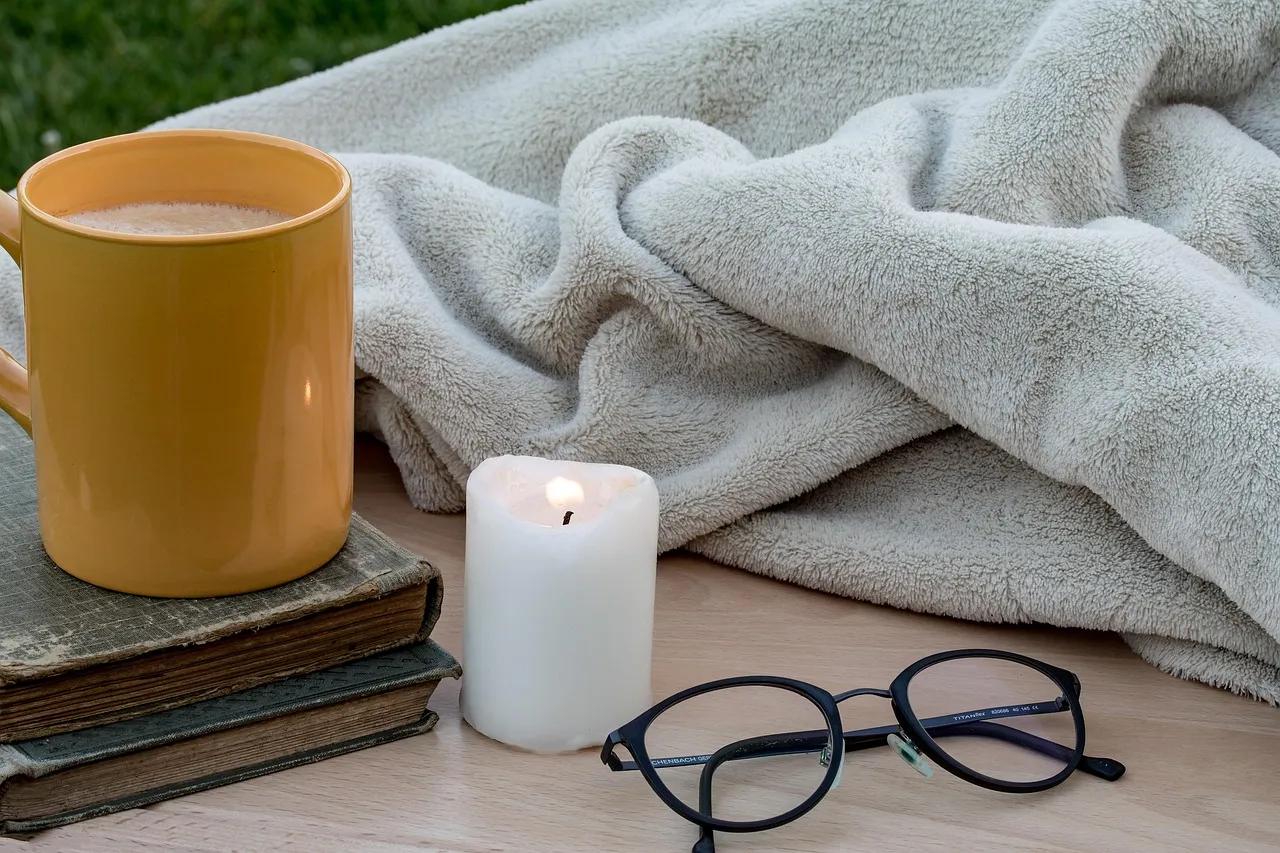 candle, flickering flame, coffee pot, cup, closed books, old books, reading glasses, ceiling, blanket, cold night, quitting time, fresh evening, comfortable, warm up, easily make, relax, outdoors, windy, ceiling, ceiling, ceiling, ceiling, ceiling, blanket