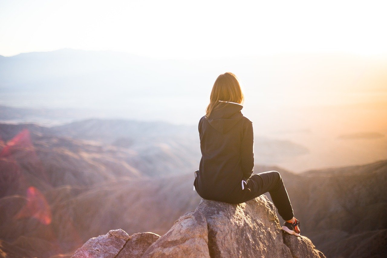 people, woman, travel, adventure, trek, mountain, rock, sunset, cliff, nature, black, hoodie, jacket, alone, thinking, freedom