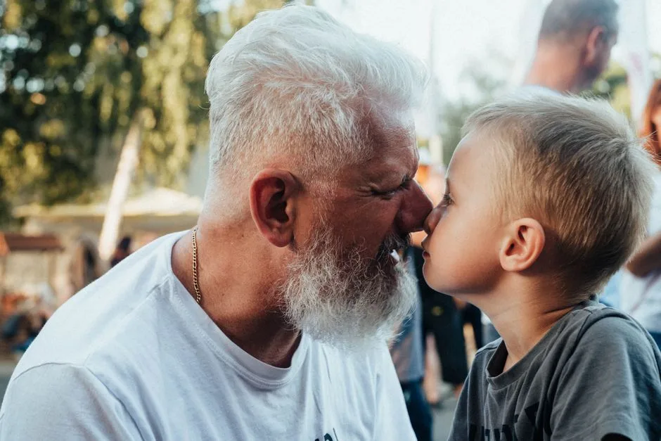 Close-up of a grandfather and grandson with noses touching, symbolizing a loving bond.