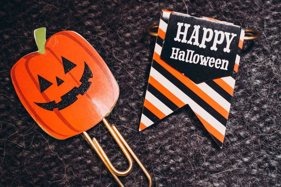 Festive Halloween paperclips featuring a pumpkin design and striped banner with 'Happy Halloween' text.