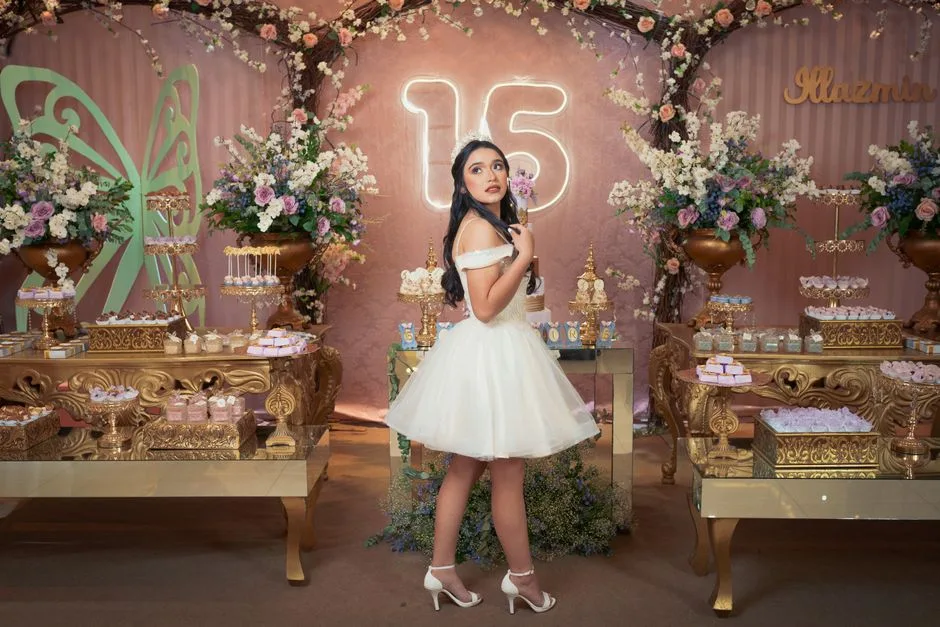 A beautiful quinceañera celebration with luxurious decorations, a teenage girl in a white dress, and elegant floral arrangements.