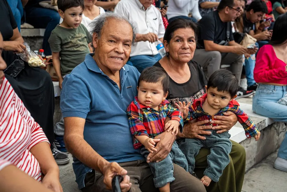 A joyful family moment captured with grandparents and grandchildren enjoying an outdoor gathering.
