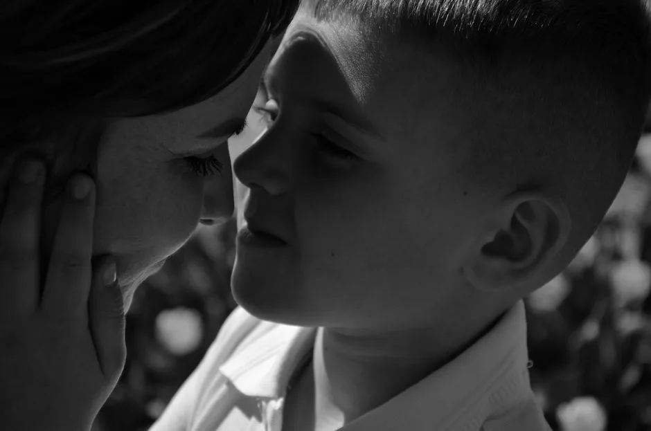 A heartwarming monochrome close-up of a mother and son sharing a tender moment.