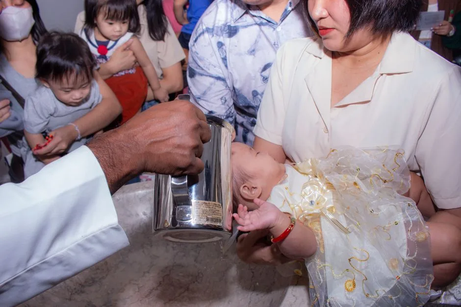 A heartfelt baptism ceremony capturing a baby's christening moment with family.
