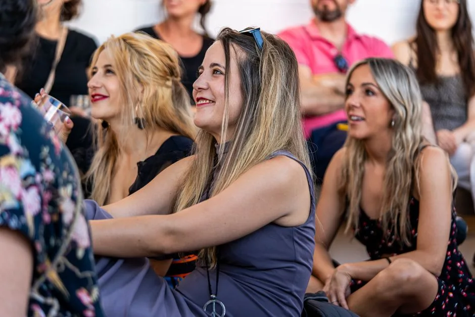 Vibrant group of adults interacting and enjoying a fun social gathering indoors.
