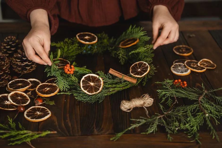 Crafting a Christmas wreath with dried oranges and pine cones adds a natural holiday touch.