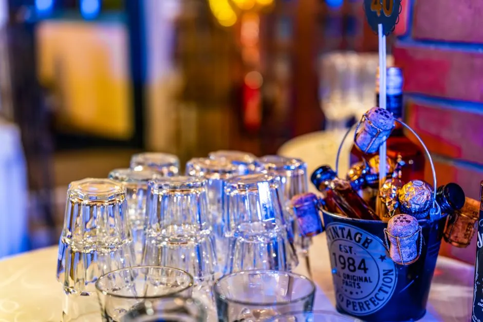 Elegant party setting with glasses, champagne, and decorations for a 40th celebration.