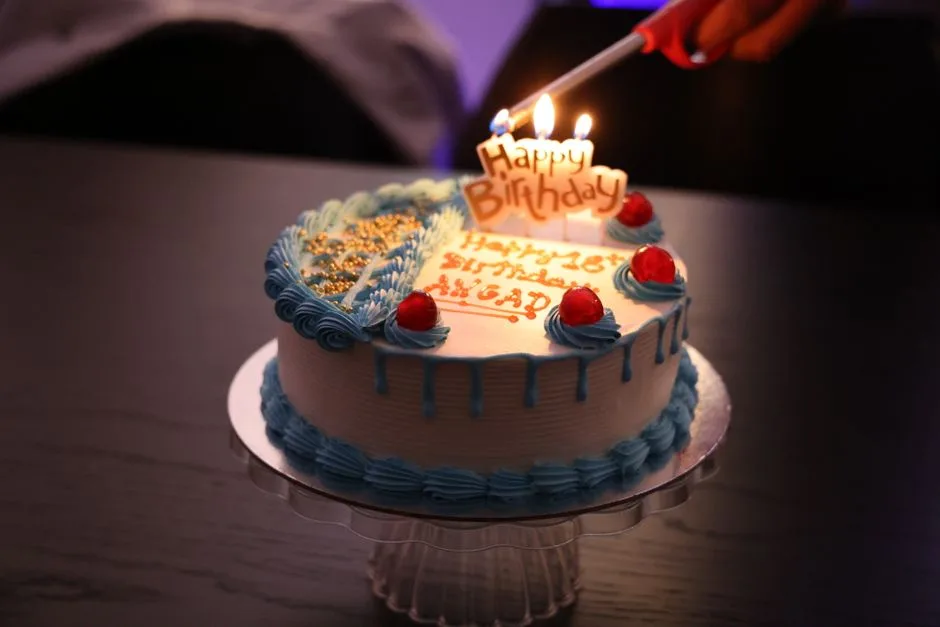 Celebrate a birthday with this beautifully decorated cake, complete with lit candles.