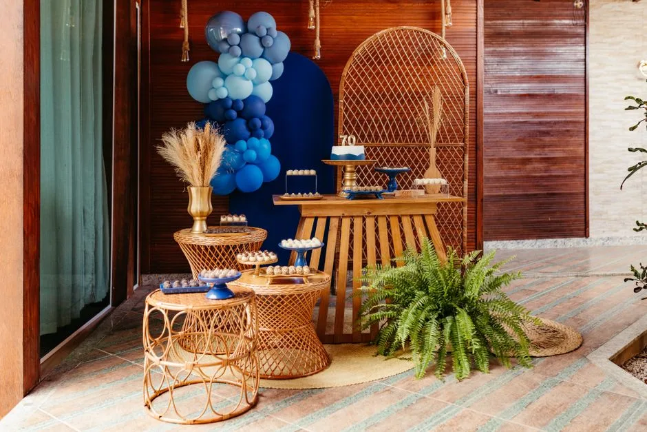 Chic 70th birthday celebration with blue balloon decor and elegant party tables.