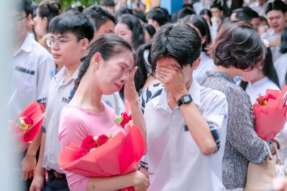 A heartfelt scene of a mother and son emotionally embracing at a graduation event.