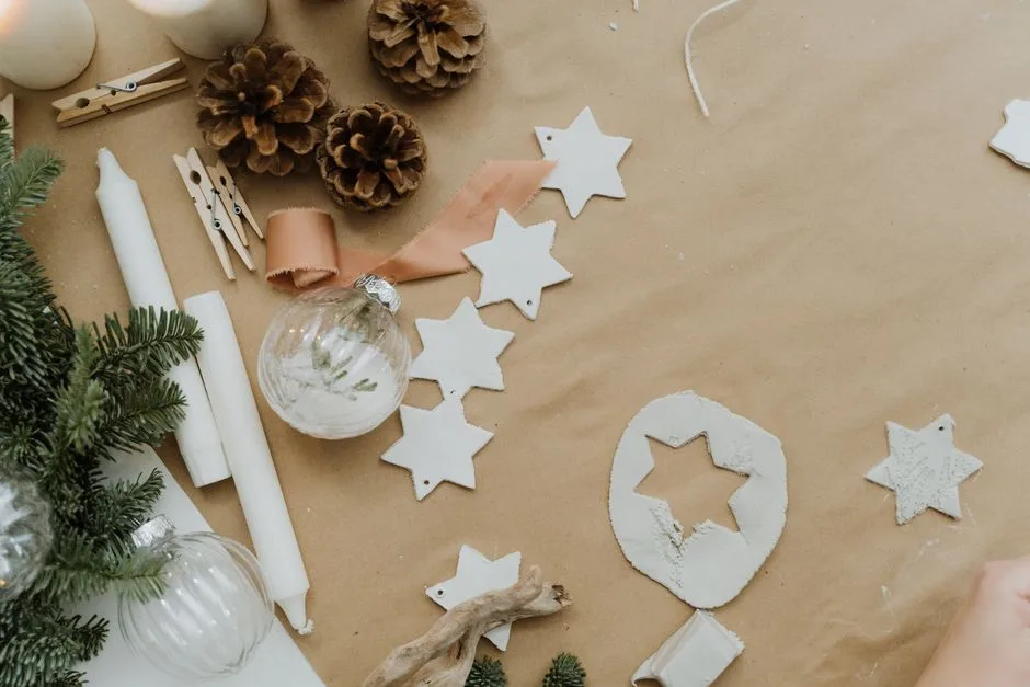 A flat lay of DIY Christmas decorations with pine cones and stars.