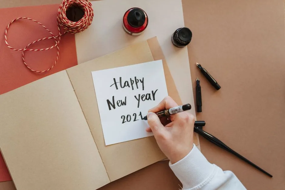Creating a handmade Happy New Year 2024 card with ink and calligraphy.