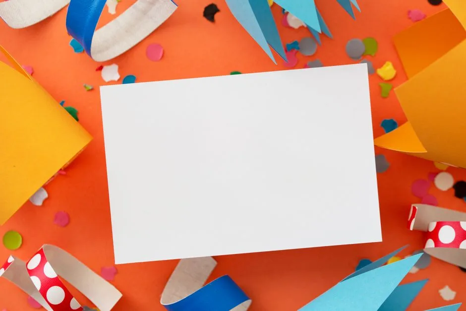 Vibrant birthday card mockup surrounded by colorful confetti and paper cutouts on an orange background.