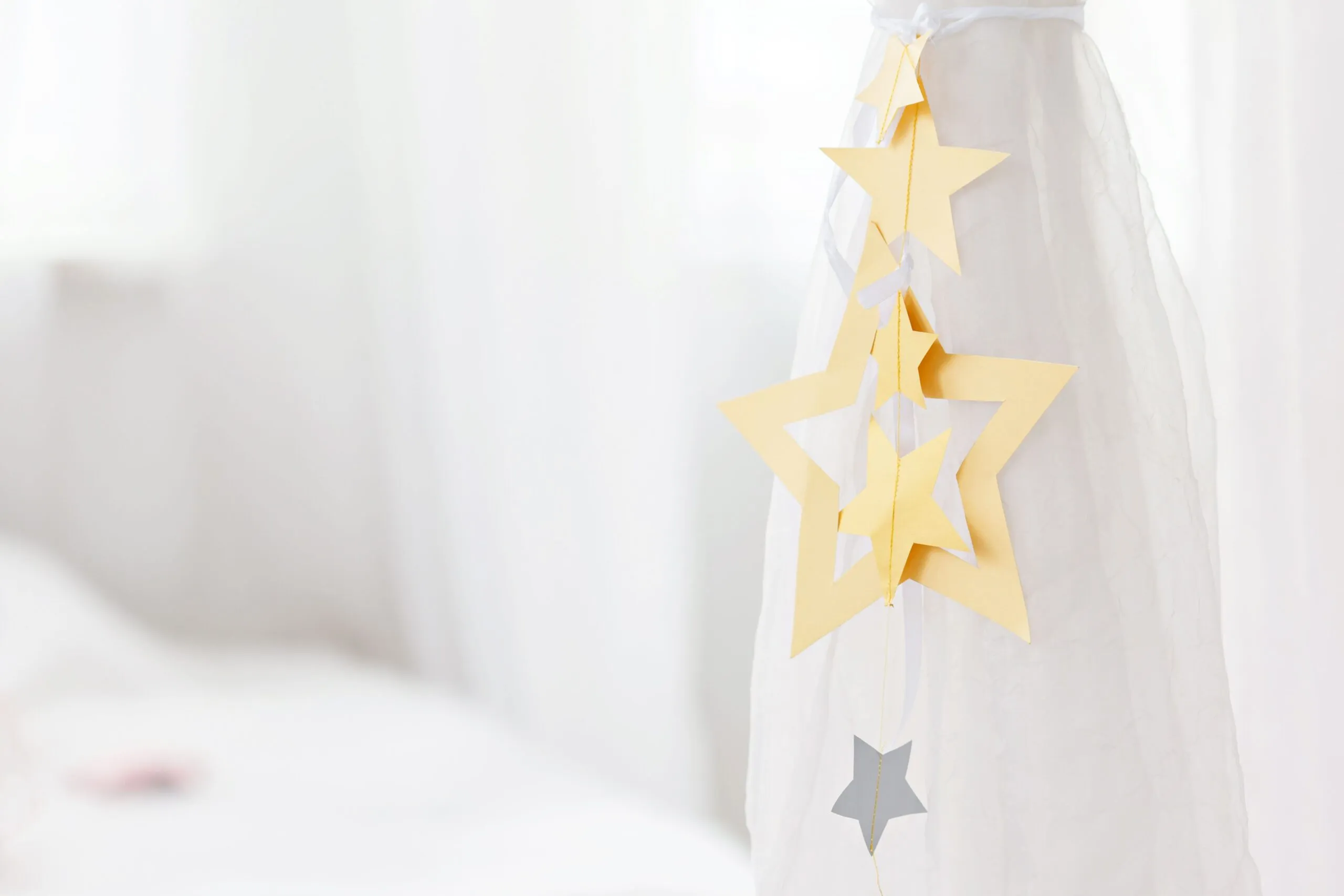 Elegant star-shaped paper ornaments on white background, ideal for minimalist decoration themes.