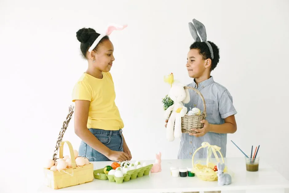 Two kids with bunny ears decorate Easter eggs, celebrating with baskets and crafts.