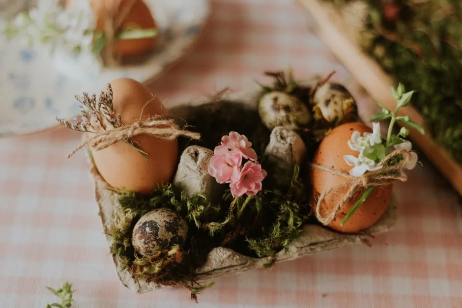Decorative Easter egg display with moss and flowers in a rustic style egg carton.