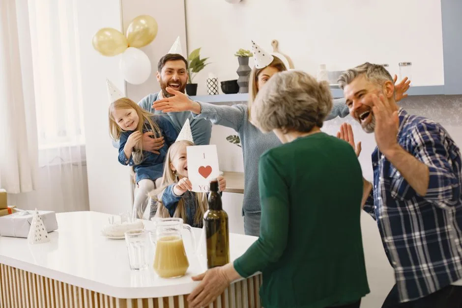 Family wearing party hats celebrating indoors with smiles and joyful expressions.