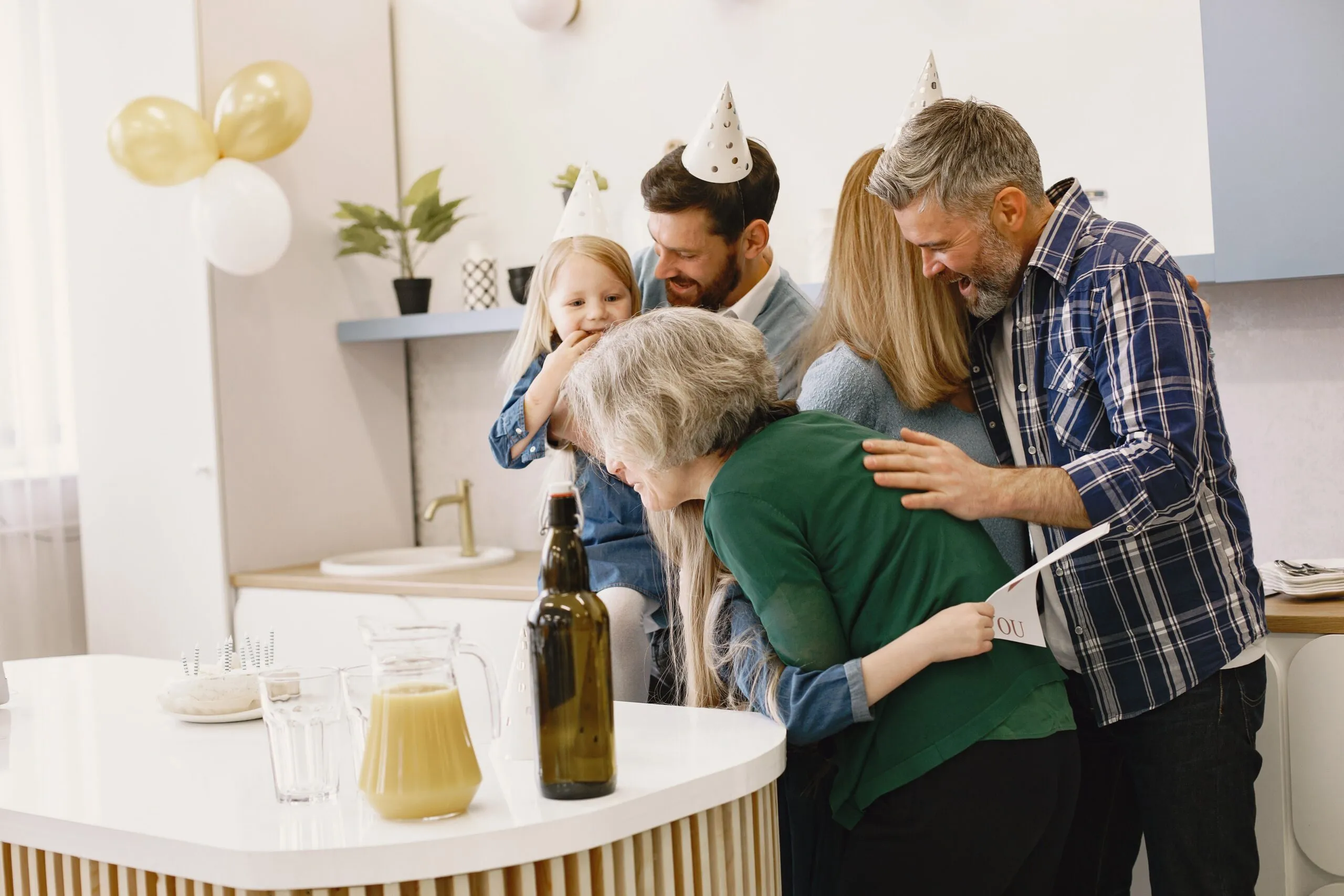 Joyful family gathering around a cake to celebrate a birthday with happiness and warmth indoors.